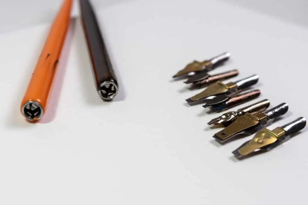 Straight nib holders and broad-edged nibs in various sizes.